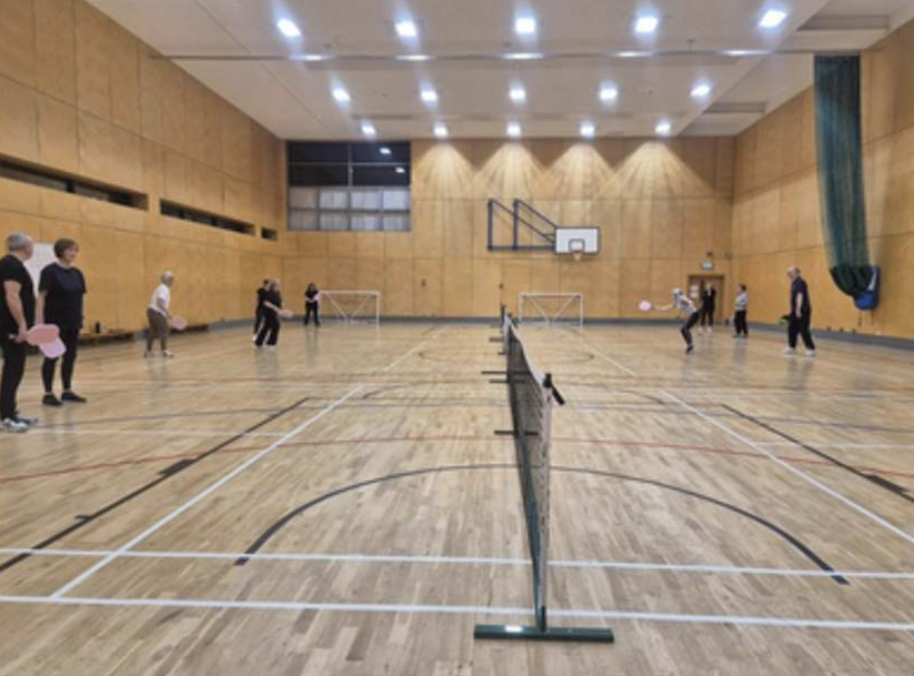 Over 50s playing Pickleball in the sports hall at Dumfries Campus