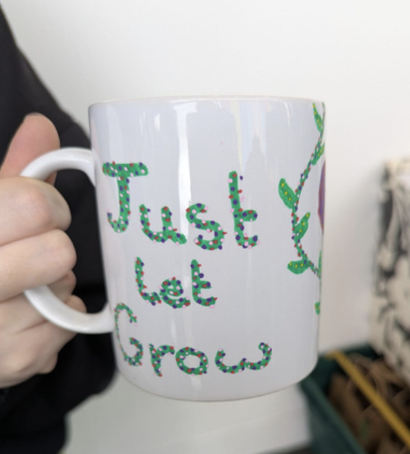One of our students displaying their decorated mug after a session with our Youth Worker Michelle Reynolds.