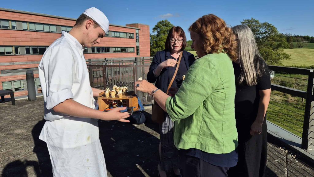 A Hospitality Student serves nibbles at a hospitality event