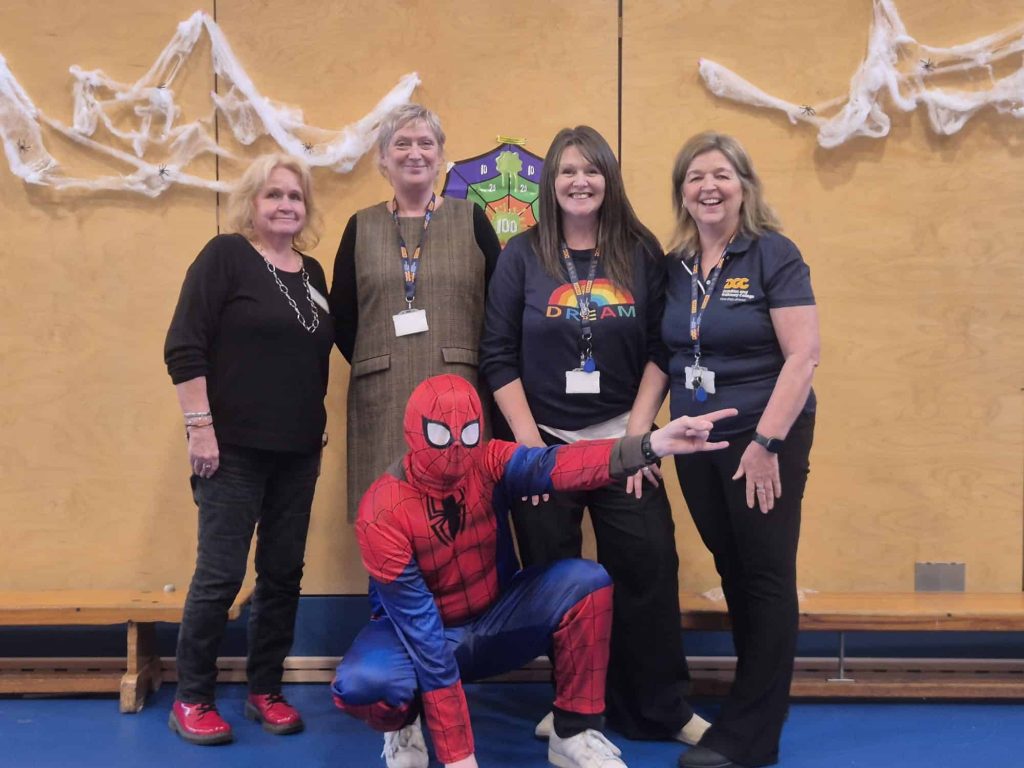 Staff posing with 'Spider Man'