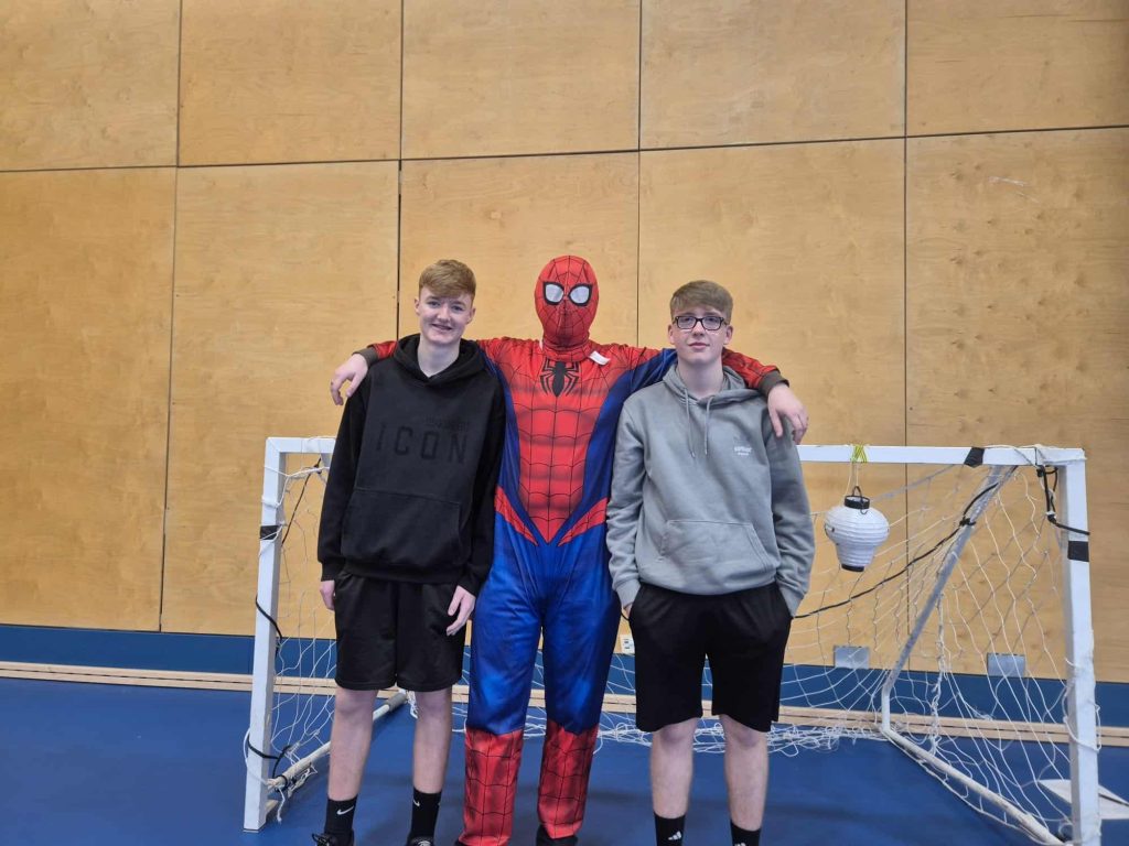 Spiderman posing with students